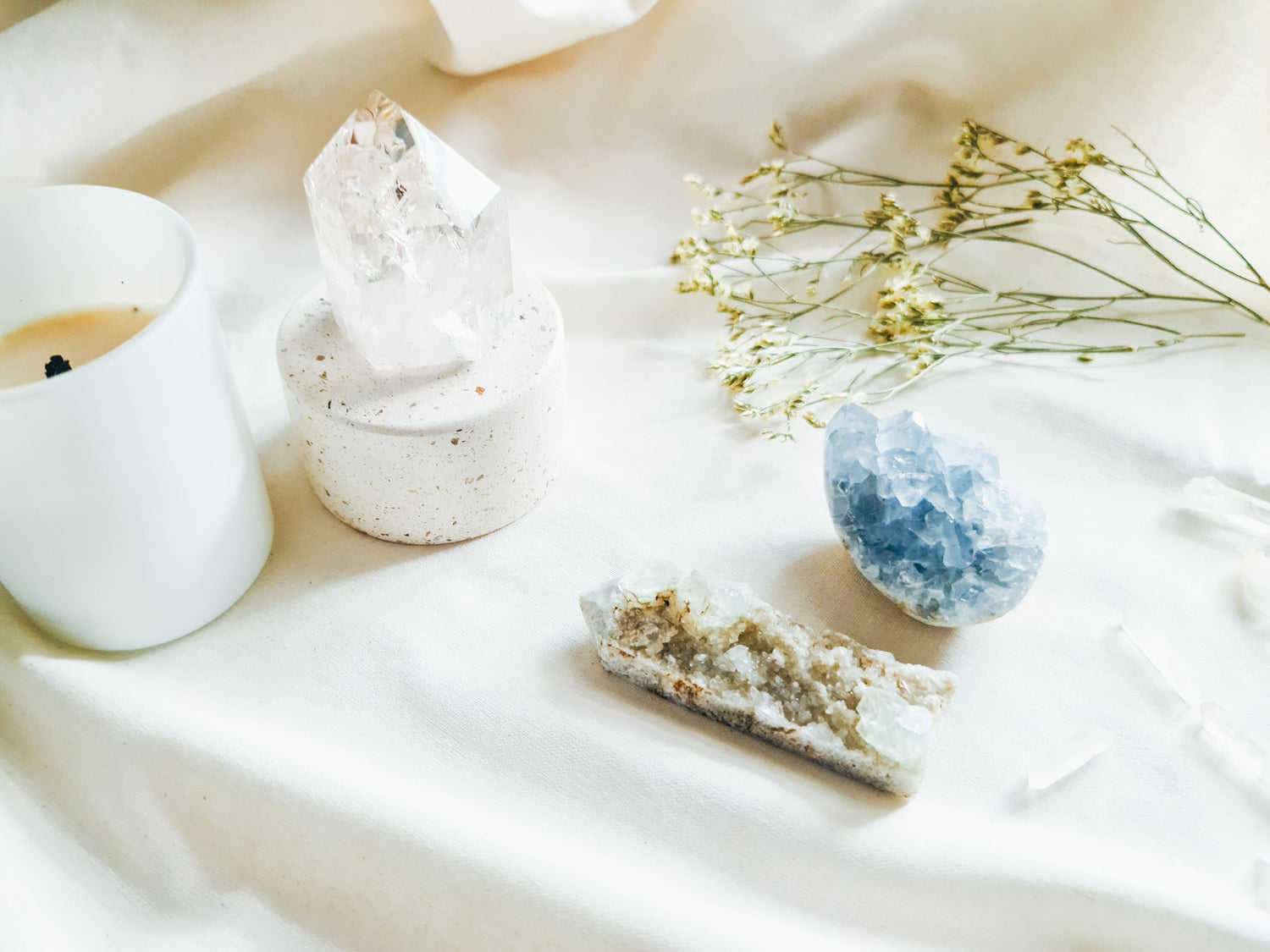 A Table topped with a candle and crystals