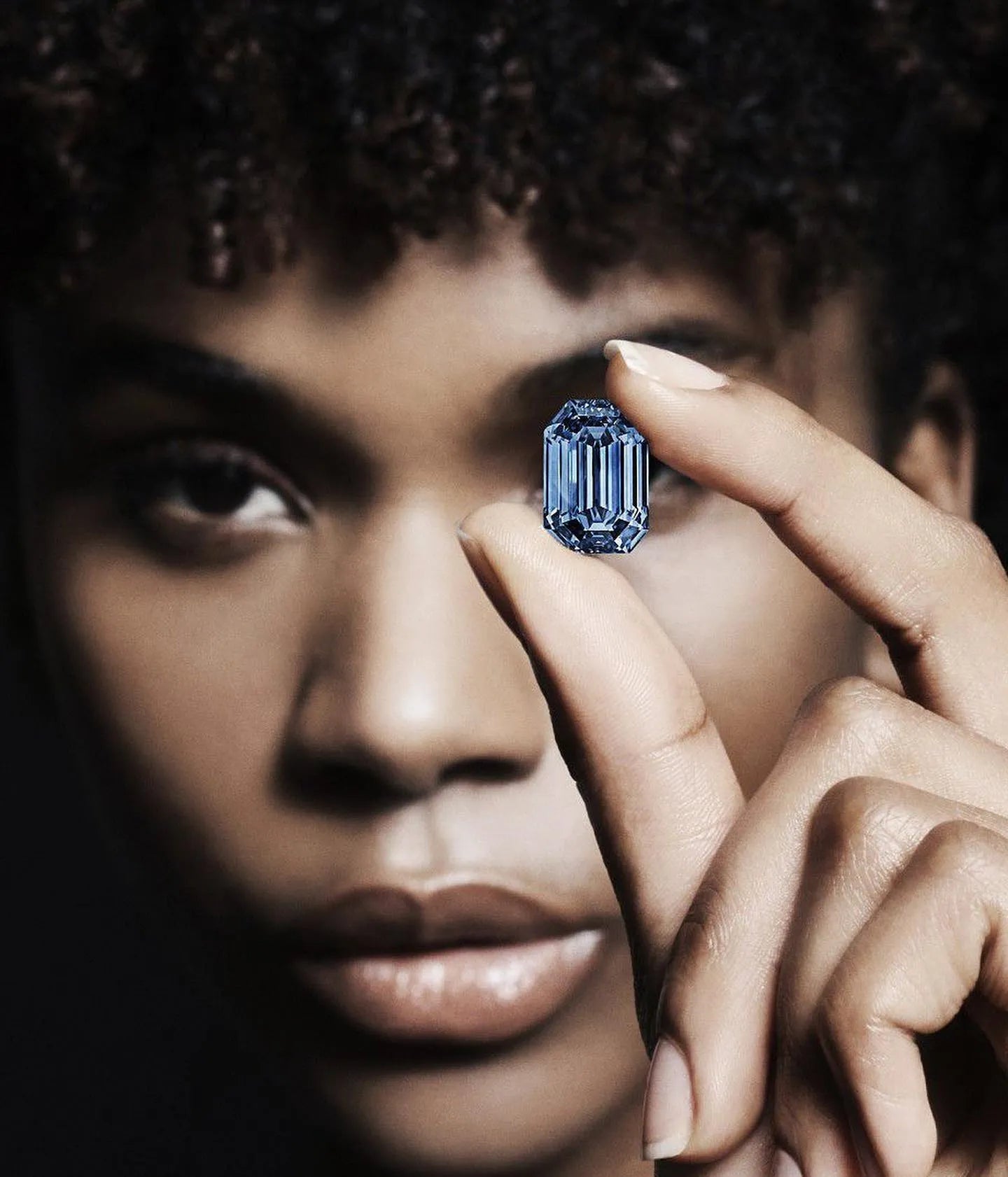 A woman holding the Oppenheimer Blue Diamond