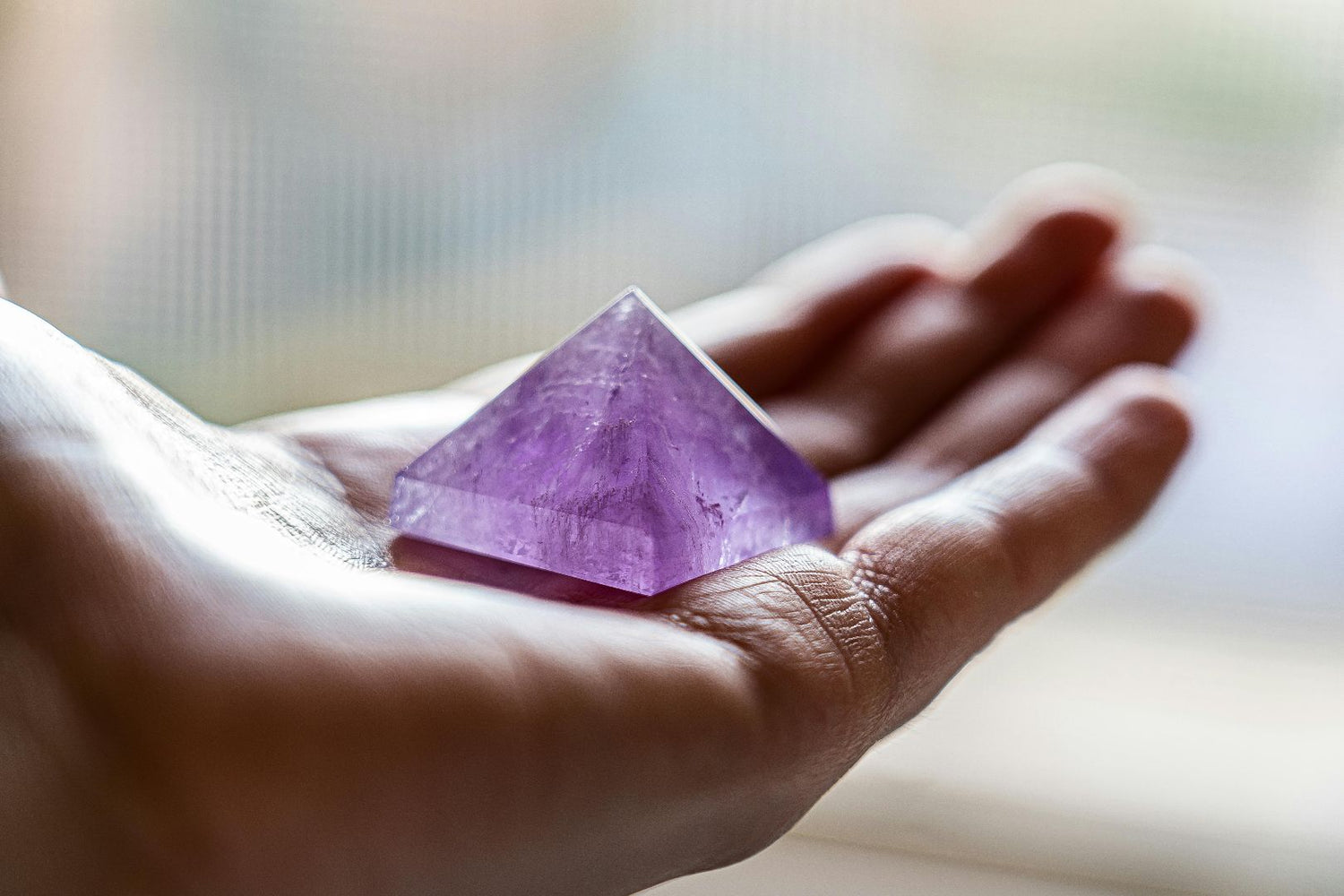 Amethyst Stone on the Palm of a Hand