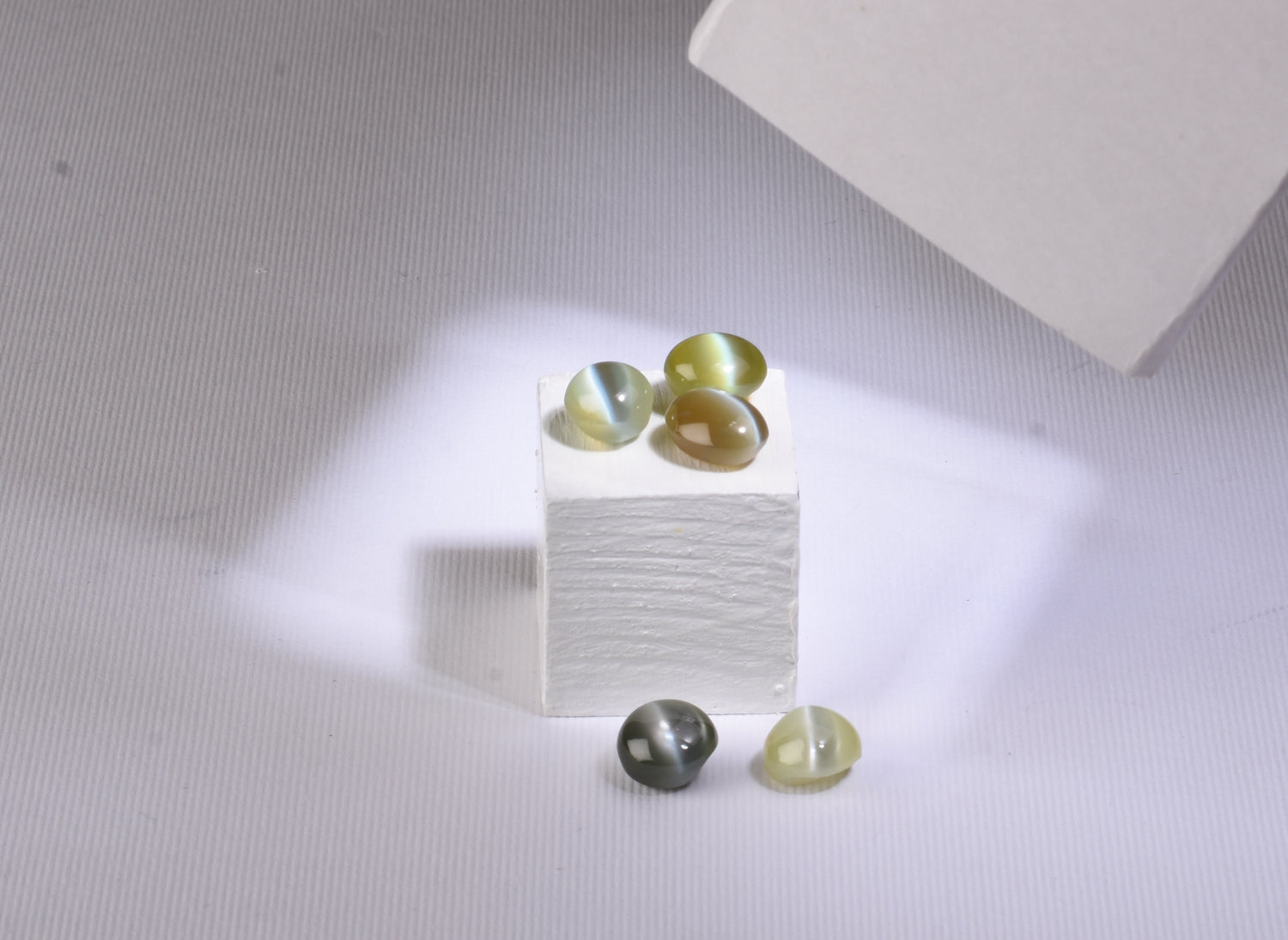 chrysoberyl cat's eye stones on a white cube