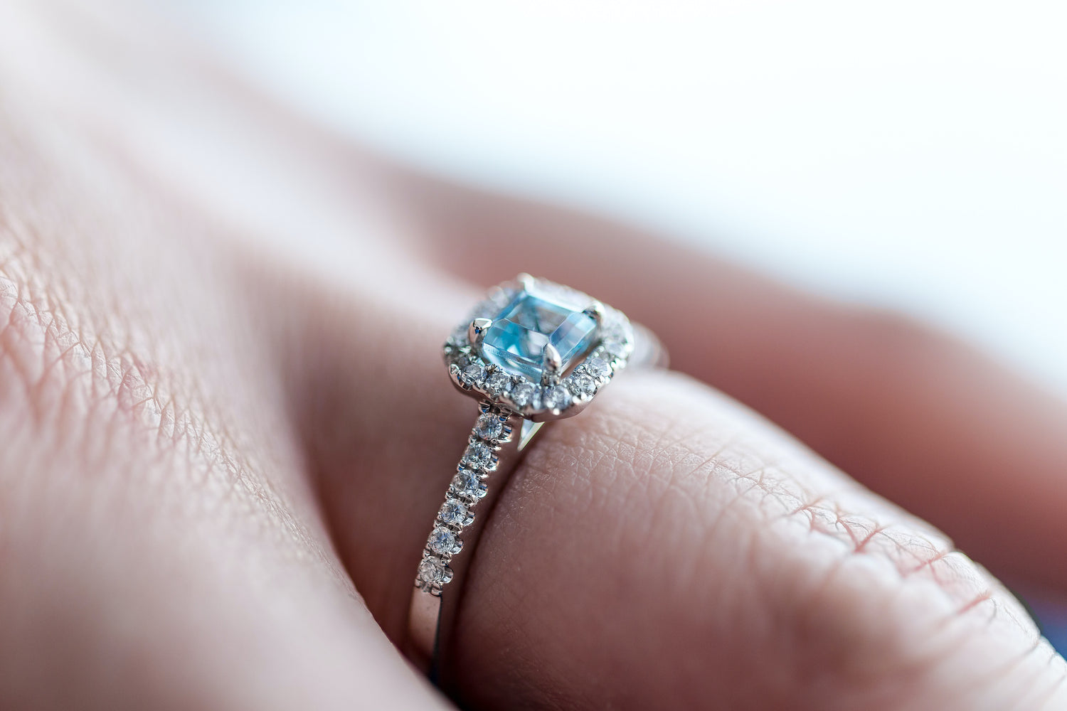 An aquamarine ring on a finger