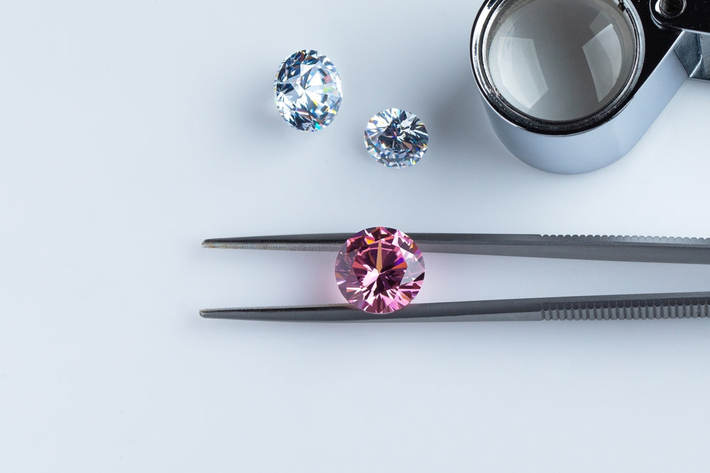 Pink diamond on a tweezer