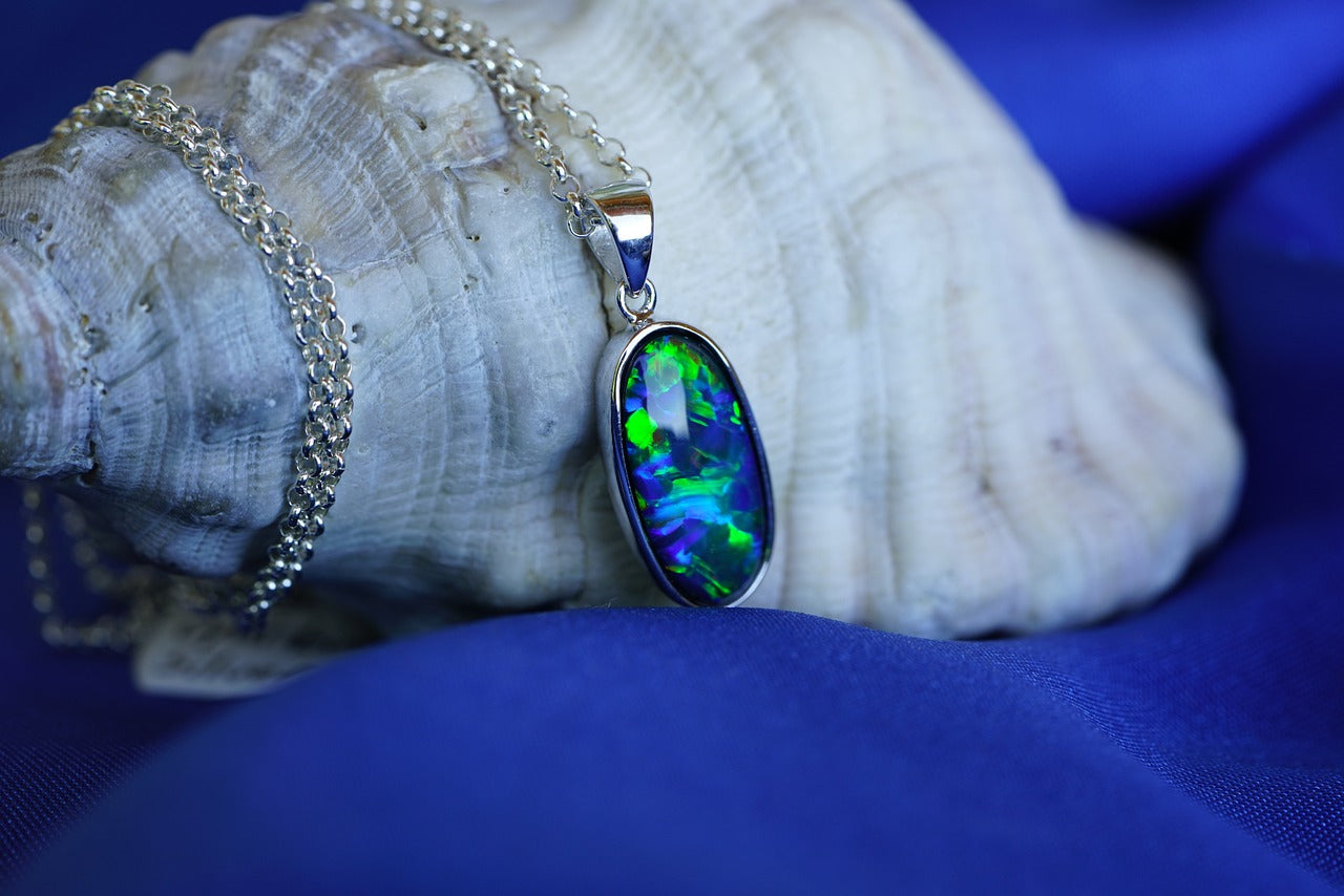 An opal necklace wrapped around an oyster