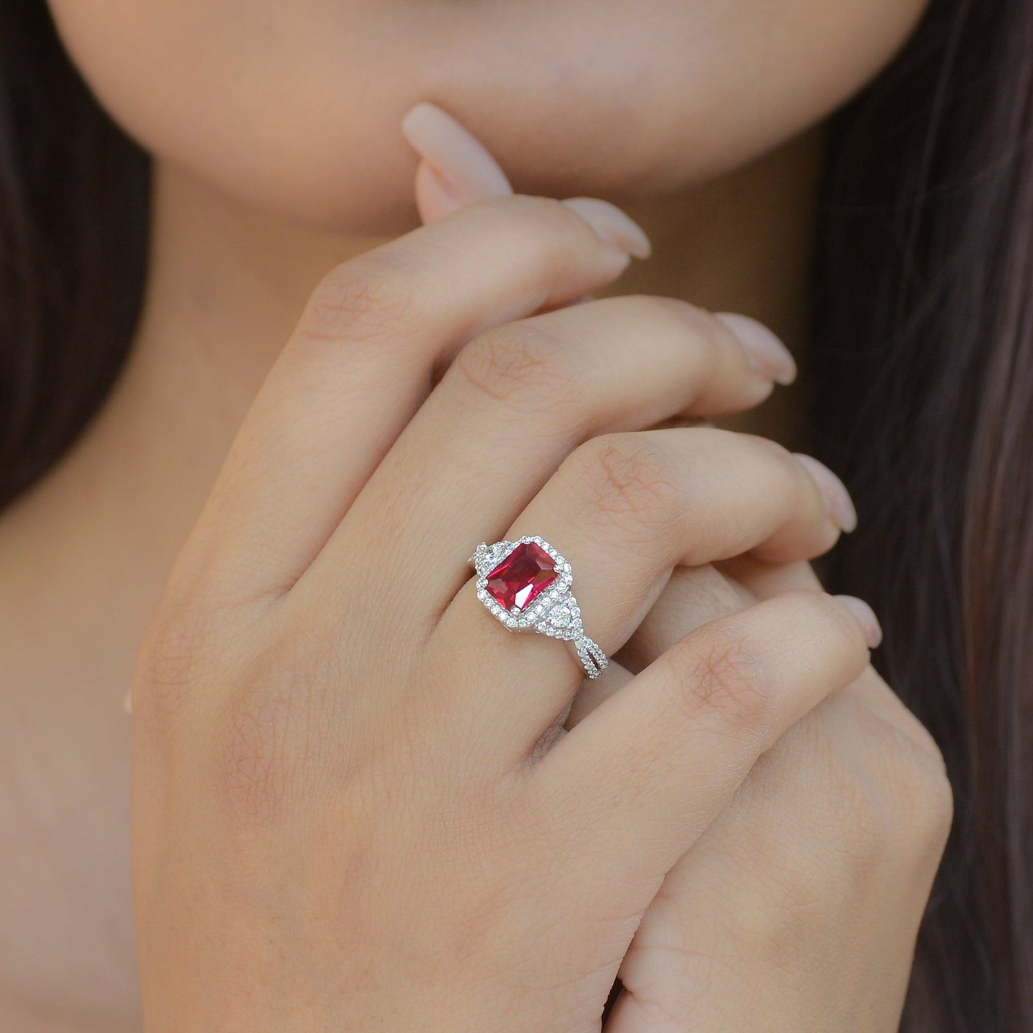 a woman wearing a ruby ring