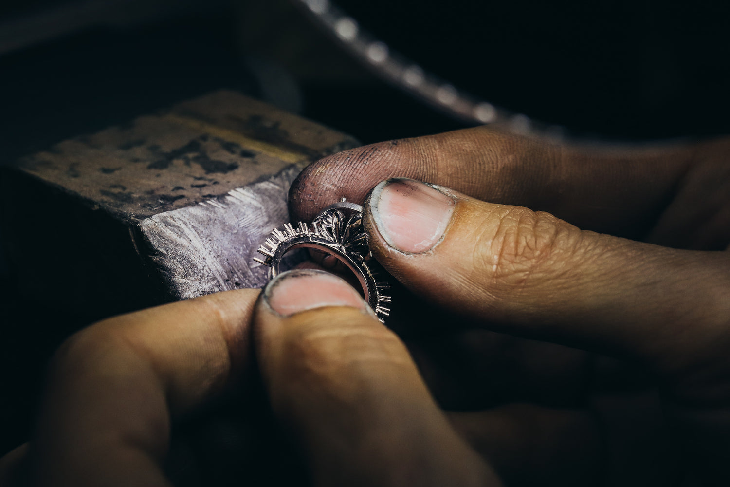 Hands examining a gemstone ring